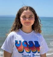 A person standing in front of a body of water

Description automatically generated