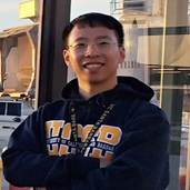A person wearing glasses and a hoodie

Description automatically generated