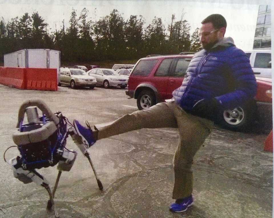 Doglike robot being kicked as part of a balance test