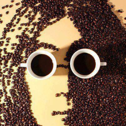 Portrait of John Lennon, made with coffee beans and two coffee cups