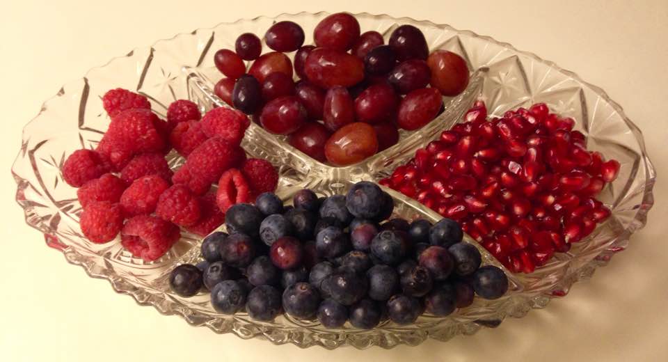 Fruit plate with berries, grapes, and pomegranate