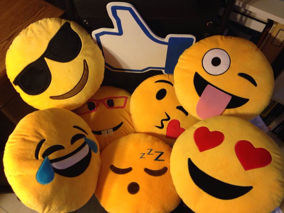 Photo of seven different emoticon cushions