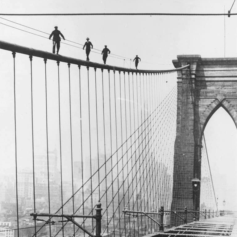 Candidates for the job of painting the Brooklyn Bridge, showing that they have what it takes