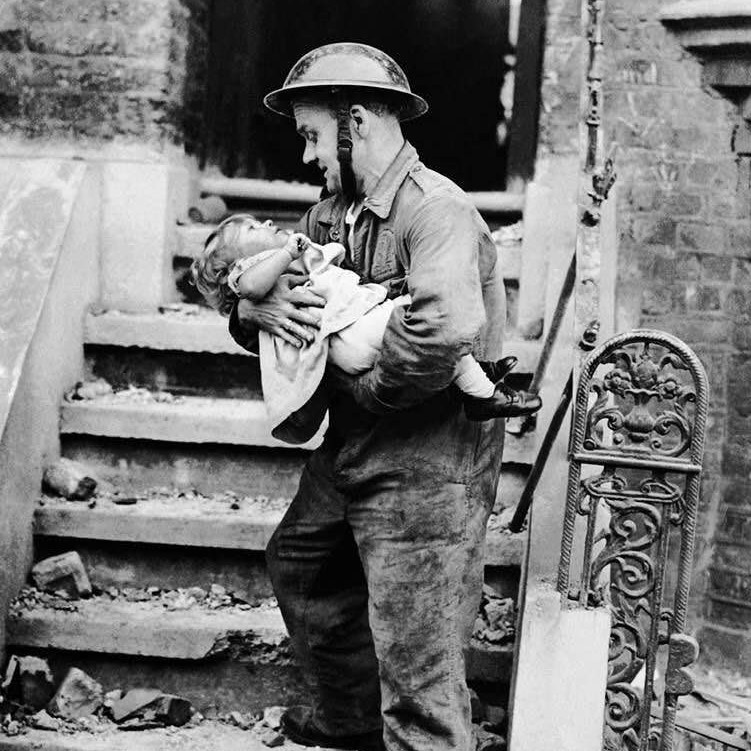 Little girl being rescued by a soldier from her London home after a series of bombings, 1944