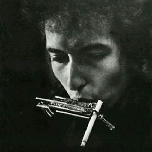 Bob Dylan, with his harmonica cigarette-holder in 1964