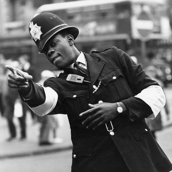 London's first black police officer, PC Norwell Roberts, on point duty near Charing Cross Station, 1968