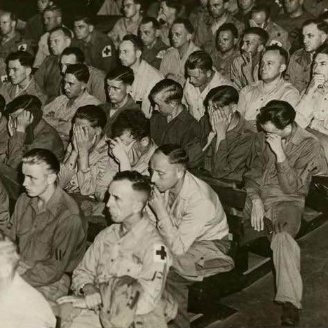 Soldiers and German townspeople react, as they are brought in to watch footage from concentration camps