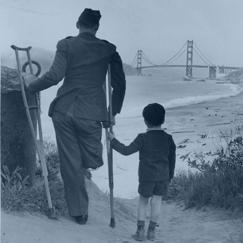 A veteran and his son gaze at the Golden Gate Bridge from the shoreline of the nearby San Francisco VA Medical Center, 1943