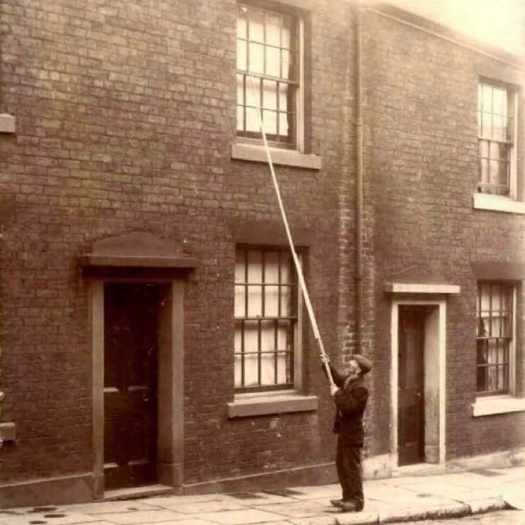 Before alarm clocks were affordable, 'knocker-ups' were used to wake people early in the morning, UK, ca. 1900