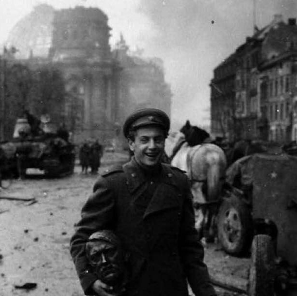 Russian soldier carries a statue head of Hitler, Berlin, May 1945