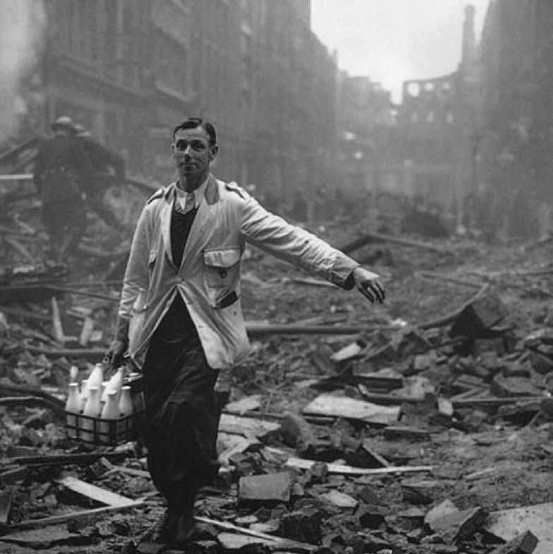 A milkman delivers milk after an air raid on London, 1940