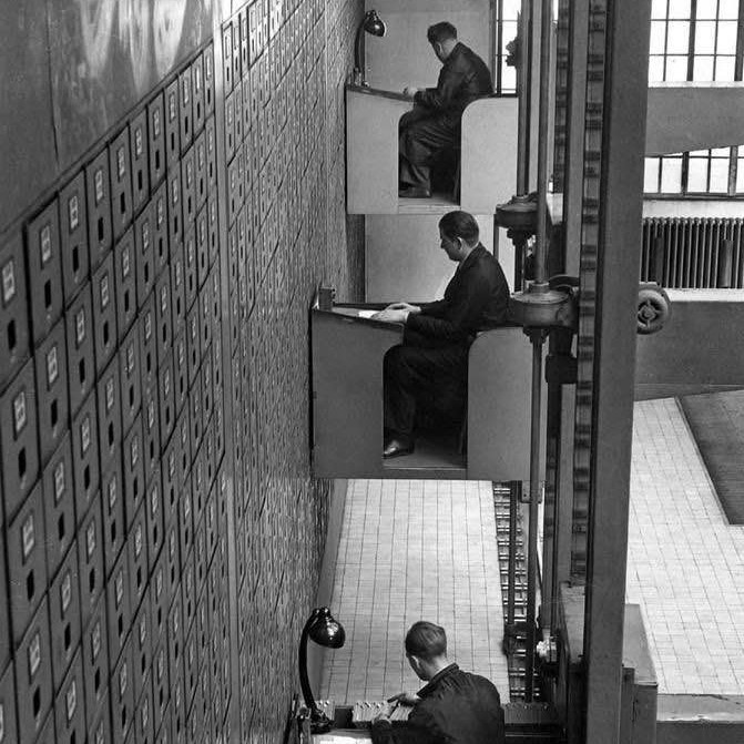 File clerks on electric elevator desks, Prague, 1937