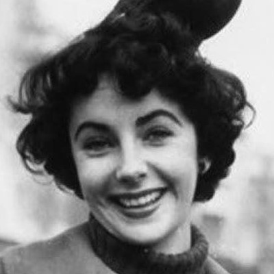 Elizabeth Taylor with a bird sitting on her head, 1948