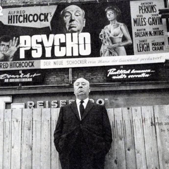 Alfred Hitchcock in front of a 'Psycho' billboard during a promotional tour in Berlin, Germany, 1960