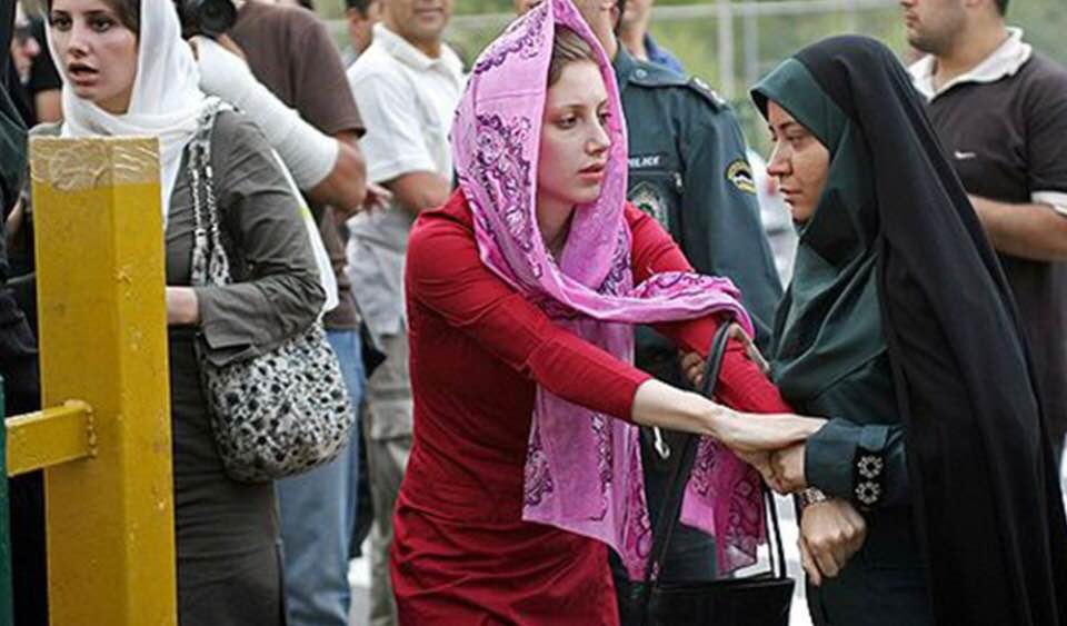 Morality policewoman questions a woman's hijab in front of Tehran University
