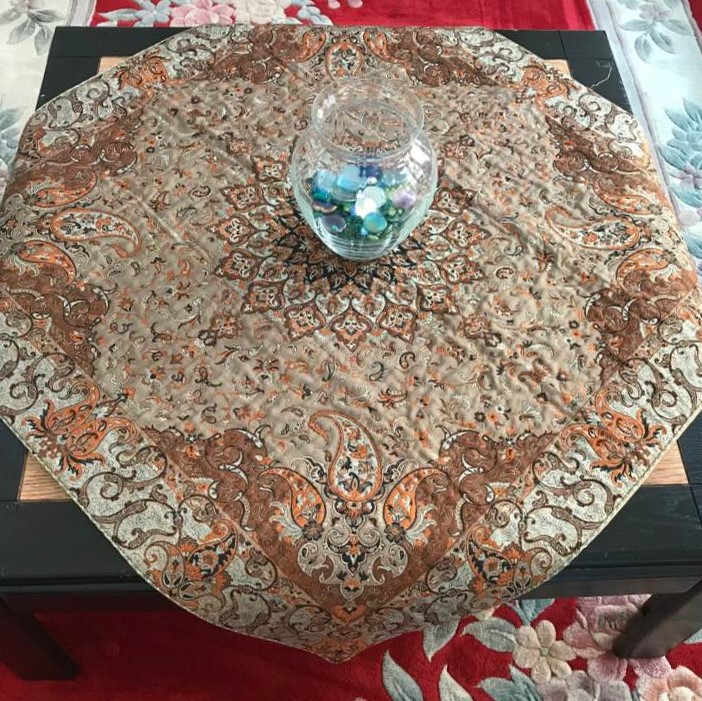 Cultural contrast: Iranian coffee-table cover, along with Chinese rug