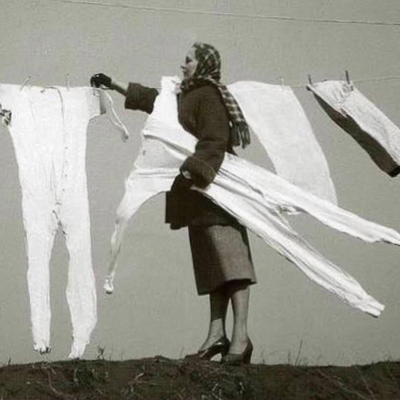 Taking frozen long-johns off the washing line, 1940s