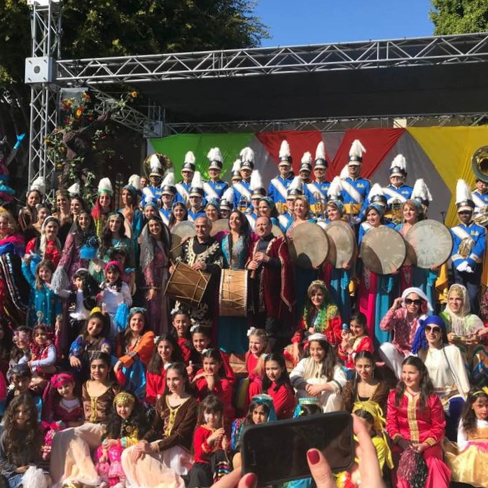 Performers posing with women in costumes at UCLA's 2019 Norooz celebration