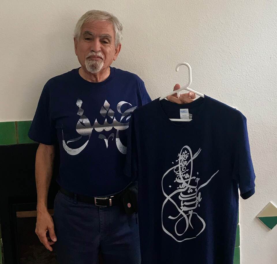 Two T-shirts bearing Persian calligraphic art