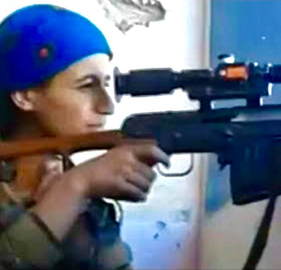 Kurdish fighter keeping watch from her lookout