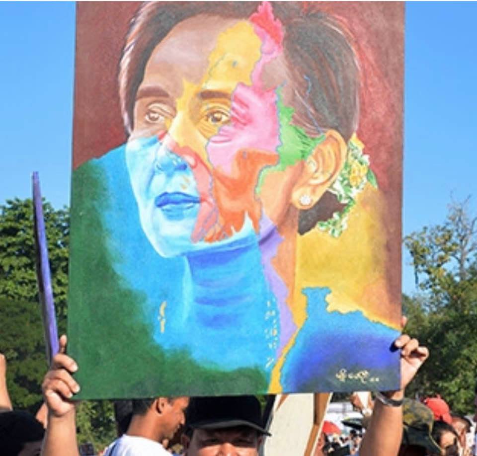 Protesters hold an image of Aung San Suu Kyi, who will be defending Myanmar against charges of genocide at the International Court of Justice in The Hague