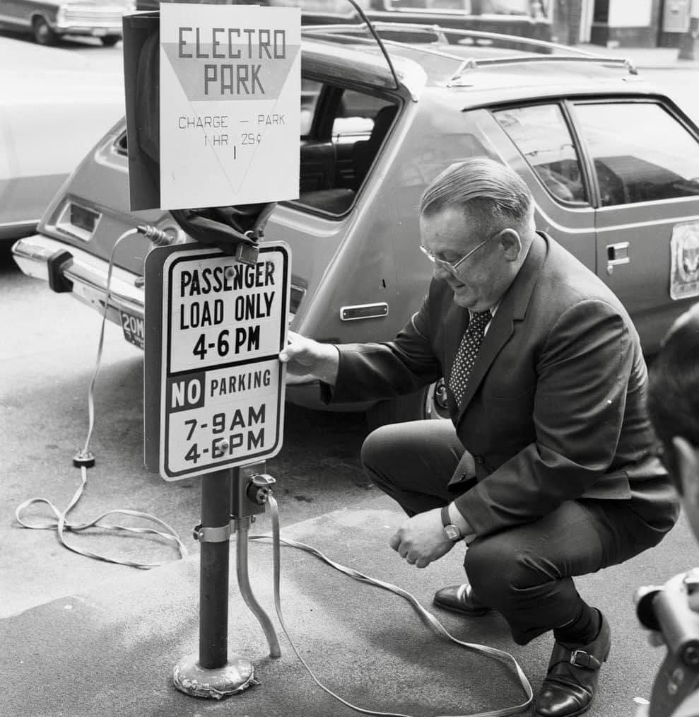 Charging an electric AMC Gremlin at a curbside charging station, 1 hour for $0.25 (Seattle, 1973)