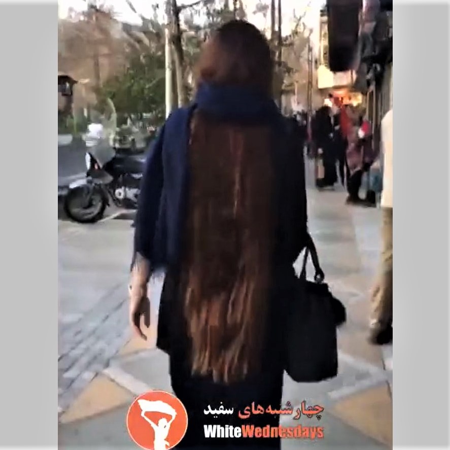 This brave Iranian woman flaunts her beautiful, super-long hair on a street in Tehran, in defiance of the Islamic government's compulsory hijab law