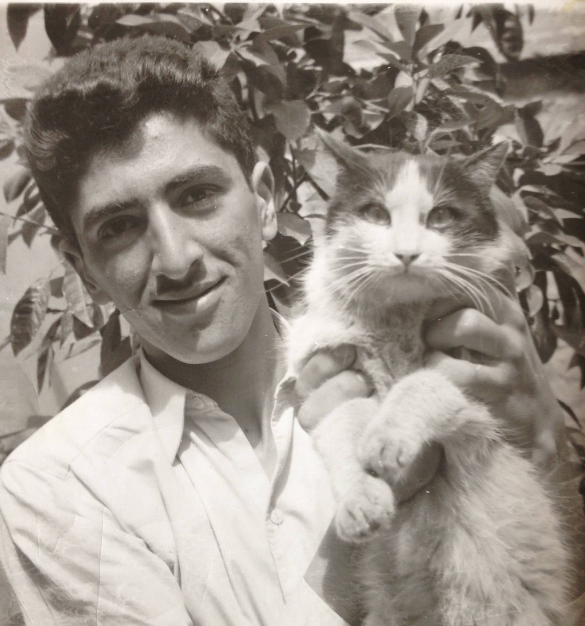 My uncle Farrokh, in his youth, shown holding a big Persian cat
