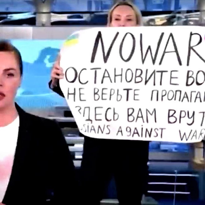 Russian TV employee holds an anti-war protest sign during a live news broadcast