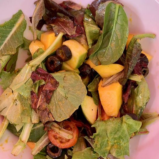 I don't know if Mango-olive salad is a standard dish, but do try it if you find it