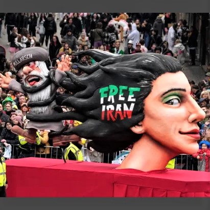 Iranians protesting against the brutal Islamic regime on February 20, 2023, in Dusseldorf display a statue showing a mullah entrapped in a woman's hair