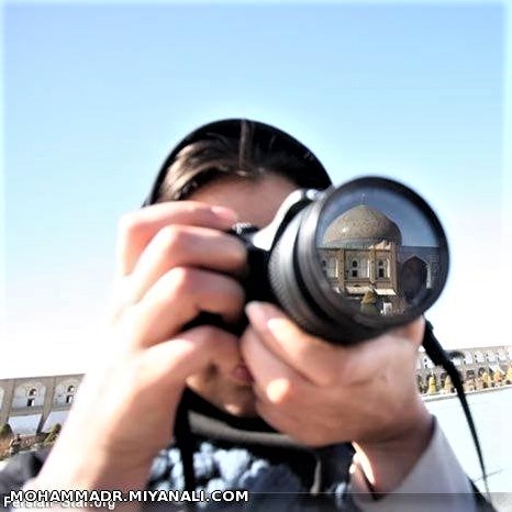 A beautiful mosque in Esfahan, Iran, reflected in a photographer's camera lens