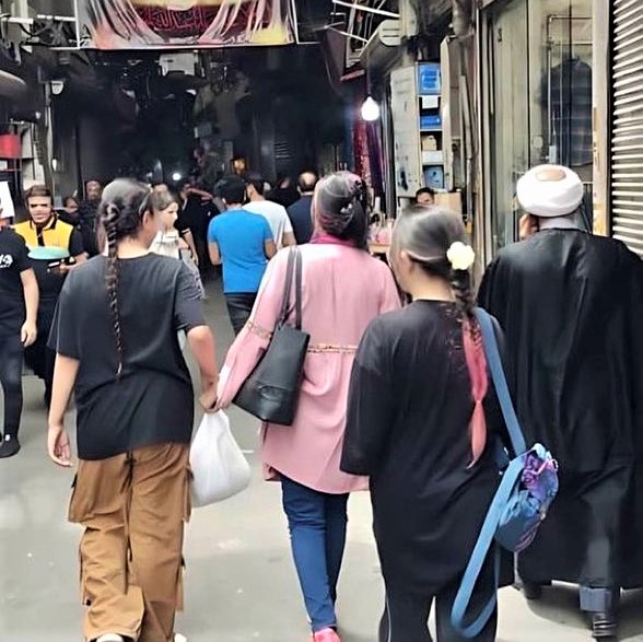 Women walking unveiled on a street in Tehran, Iran