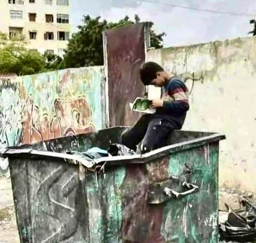 Iranian boy looking for food in a dumpster, finds a book instead