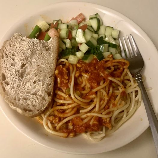 Multicultural dinner: Italian pasta with meat sauce, Iranian Shirazi salad, and French bread