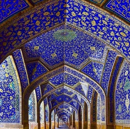 The perfect symmetry and the signature blue tiles of Shah Mosque, Isfahan, Iran