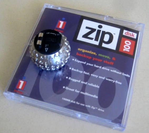 Throwback Thursday: Two relics of the past, an Iomega Zip disk and an IBM Selectric typewriter’s golf-ball Persian font